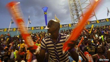 Fans cheer during Jamaica's Inter-Secondary Schools Boys and Girls Athletics Championships, also known as Champs, in Kingston, 31 March 2012