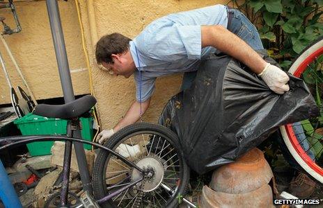 Person removing snails from house facade