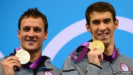 US swimmers Michael Phelps (r) and Ryan Lochte (l) show their gold and silver medals after the men's 200m individual medley swimming event at the London 2012 Olympic Games