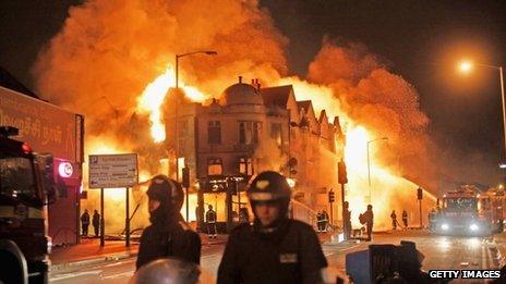 Firefighters battle a large fire that broke out in shops and residential properties in Croydon