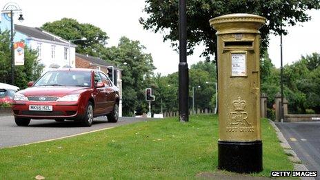 Gold-painted postbox