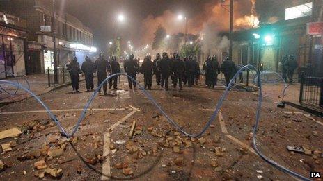 Riot police on devastated street