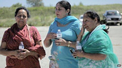 People outside the Sikh Temple in Oak Creek, Wisconsin, where a shooting took place on 5 August 2012