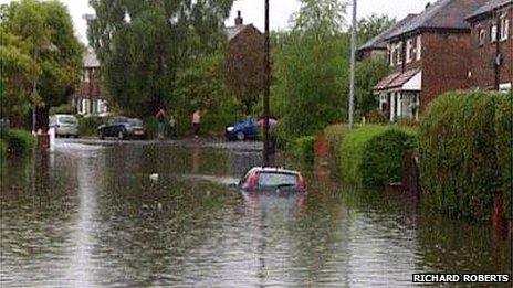 A car submerged by flood water in Prestwich