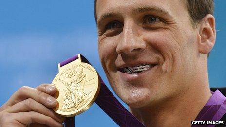 Ryan Lochte smiles, showing his jewelled teeth