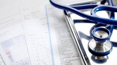 Blood test and other health check results beside a stethoscope