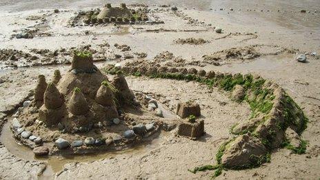 A sand castle guarded by a dragon