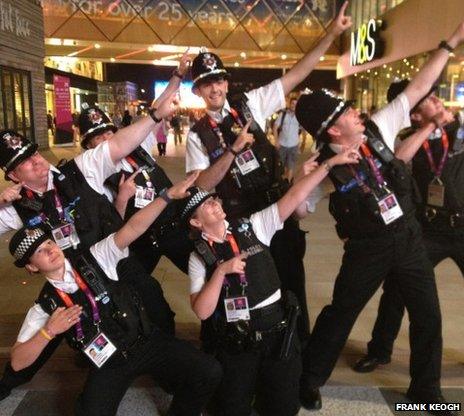 Police officers pose after Usain Bolt's win