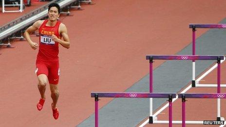 China's Liu Xiang hops down the track after crashing into the first hurdle and failing to finish his men's 110m hurdles heat at the London 2012 Olympic Games at the Olympic Stadium 7 August, 2012