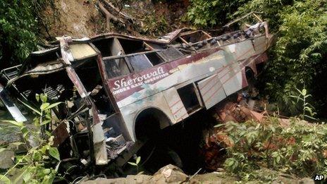 Wreckage of a passenger bus is seen after it fell into a gorge in Tongseng village in Meghalaya state, India, Wednesday, Aug. 8, 2012.