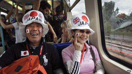 Two visitors from Japan ride the train to go and watch the judo competition at the 2012 Summer Olympics