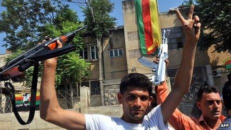 Syrian Kurds hold their rifles in Jinderes, near the northern Syrian city of Aleppo, 22 July 2012