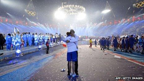 Two athletes hug at the closing ceremony of the 2012 London Olympic Games