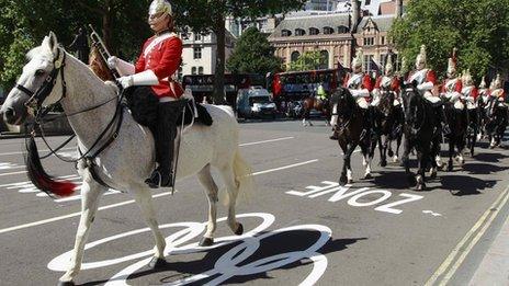 Members of the Household Cavalry ride down an Olympic Lane