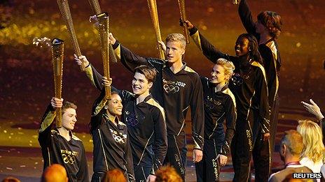 Seven final torchbearers prepare to light the Olympic Cauldron. Seven teenagers, in keeping with the Games motto of "Inspire a generation"