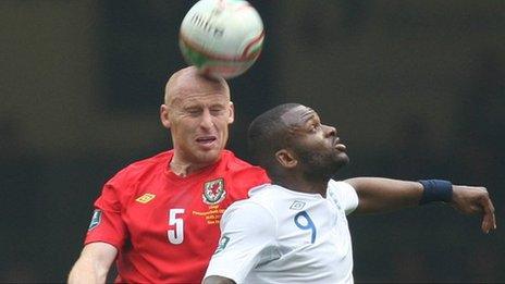 James Collins challenges England's Darren Bent in his last game for Wales in March 2011