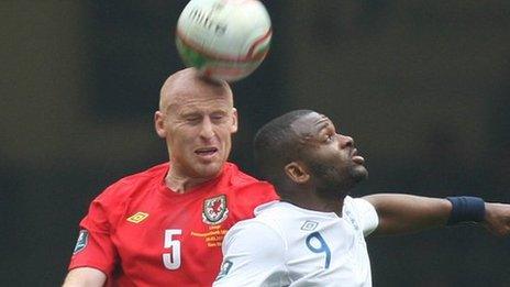 James Collins yn herio Darren Bent o Loegr yn ei gêm olaf dros Gymru ym mis Mawrth 2011