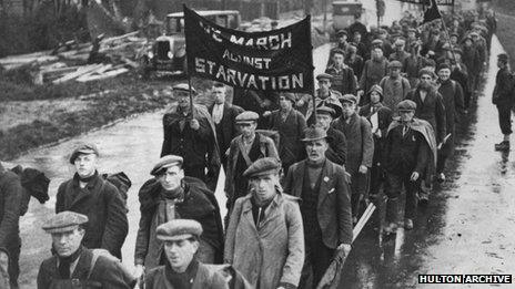 Unemployed men on a hunger march pass through a British town, circa 1935.