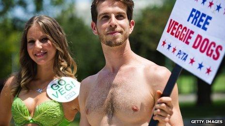 Woman in lettuce bikini and friend