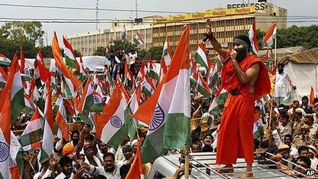 Baba Ramdev addresses supporters on the way to an anti-corruption protest