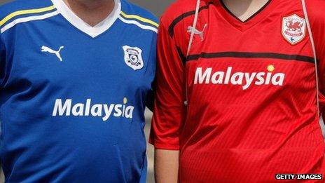 Father and son pose in away and home shirts