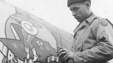 Nose artist Don Allen painting Miss Dallas on a plane