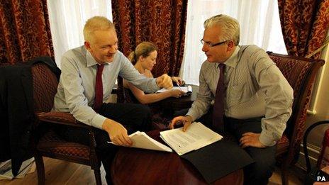 Julian Assange talking with his legal adviser Baltasar Garzon