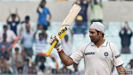 India's VVS Laxman raises his bat to celebrate his century on the second day of their second test cricket match against West Indies in Kolkata in this November 15, 2011