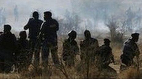 Policemen fire at striking miners at the Marikana platinum mine in South Africa on 16 August