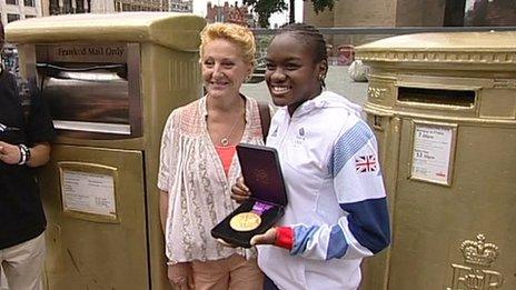 Nicola Adams and two gold postboxes