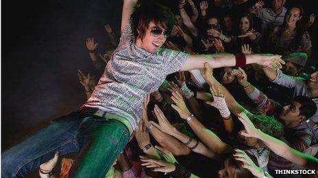 Person surfing the crowd in a mosh pit