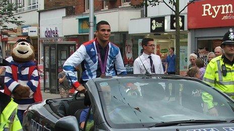 Anthony Ogogo in an open top car in Lowestoft with his Olympic medal