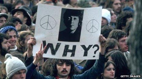 Fans of former Beatle John Lennon at a vigil on 8 December 1980 outside the Manhattan apartment block where he was shot dead by Mark David Chapman.