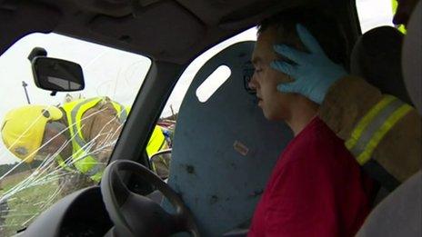 Firefighters taking part in a mock car crash rescue