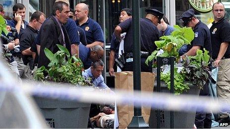 Police and a victim at the scene of a shootout in front of the Empire State Building, New York 24 August 2012