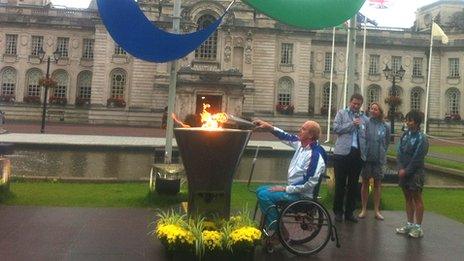 Paralympian Simon Richardson lights the flame outside Cardiff City Hall