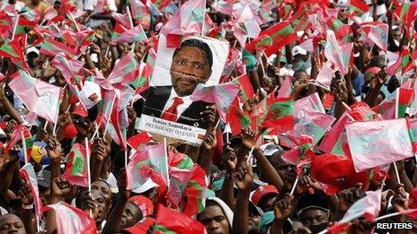 Supporters of Angola's opposition UNITA party with a poster showing their leader Isaias Samakuva during an election rally in Luanda