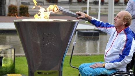 Simon Richardson sparks the Paralympic flame outside Cardiff City Hall