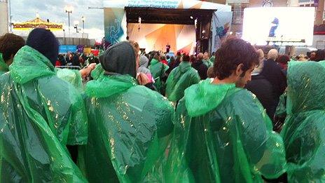 Concertgoers in ponchos