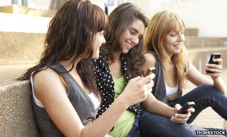 Teenagers using mobile phones