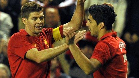 Liverpool captain Steven Gerrard congratulates goal hero Luis Suarez