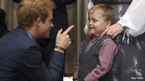 Prince Harry talks to Alex Logan, aged six, as he attends the WellChild awards ceremony at the InterContinental Hotel in London on 3 September