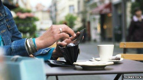 Person paying bill at cafe