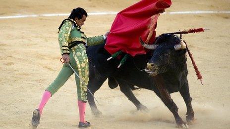 Spanish matador Leandro Marcos Vicente performs a pass during a bullfight at the Malagueta Bullring in Malaga, on August 13, 2012