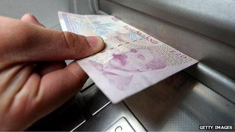 Person removing money from an ATM