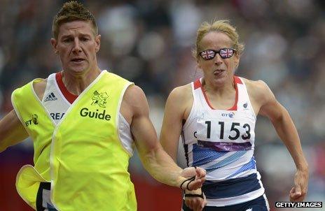 GB's Tracey Hinton (R) runs with her guide Steffan Hughes (L) during the Women's 200 metres T11 Semifinal