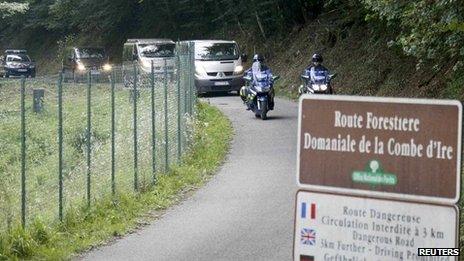 Police vehicles leave the scene of the crime