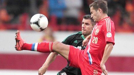 Aaron Hughes challenges Viktor Faizulin in the qualifier