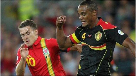 Wales captain Aaron Ramsey challenges Belgium captain Vincent Kompany