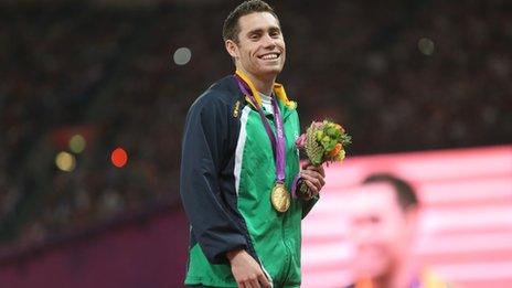 Jason Smyth smiles after being presented with his second London Paralympics gold by Lord Coe